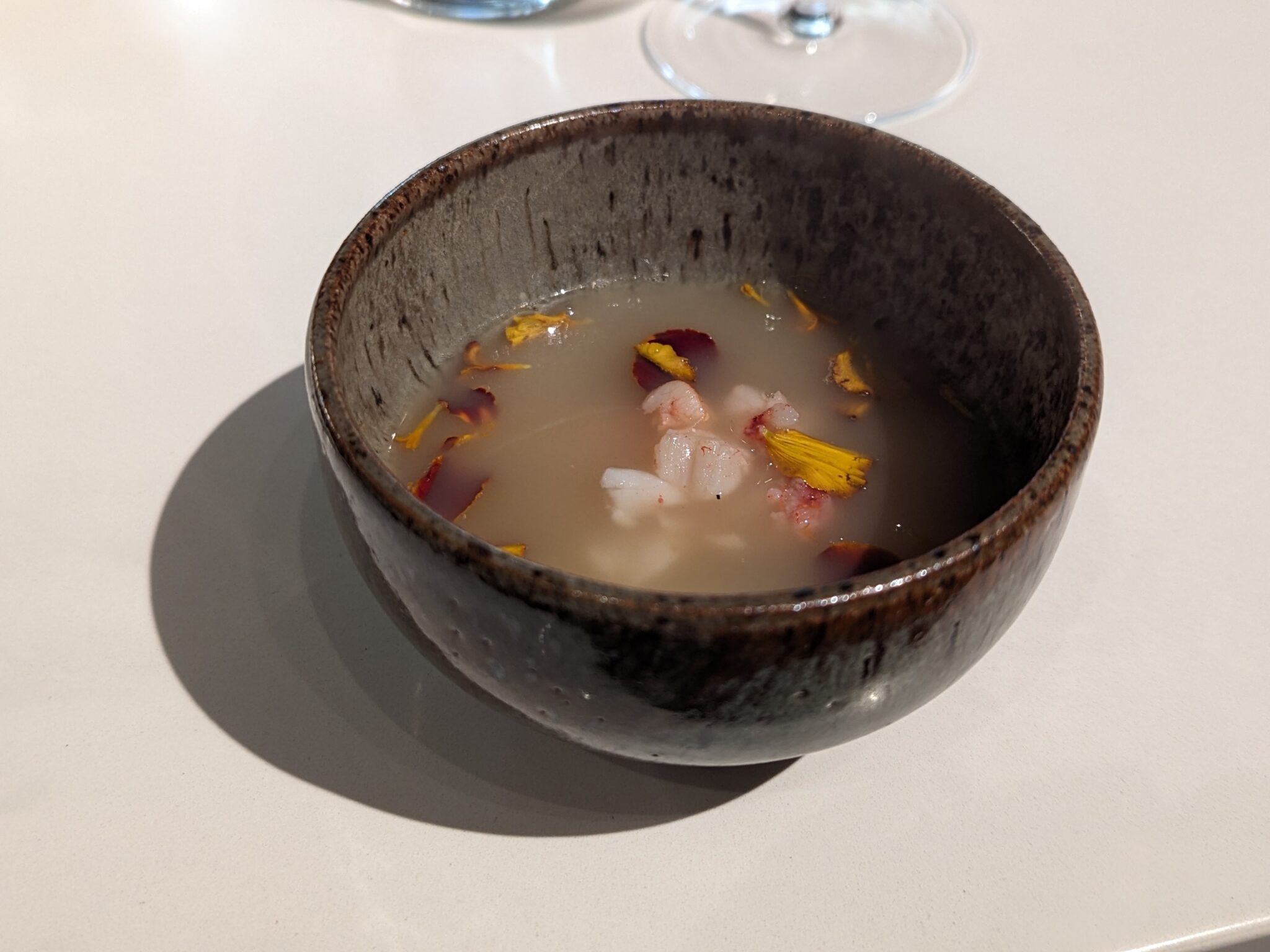 Paitan broth, lobster, grilled baby corn, marigold at Nisei